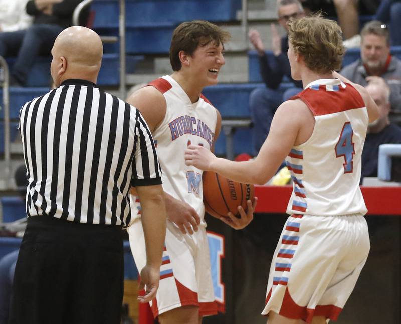 Marian Central’s Christian Bentancur is greeted by teammate, Quinn Brady, after scoring he 2,000 points during a nononference boys basketball game against Marengo on Tuesday, Feb.13, 2024, at Marian Central High School.
