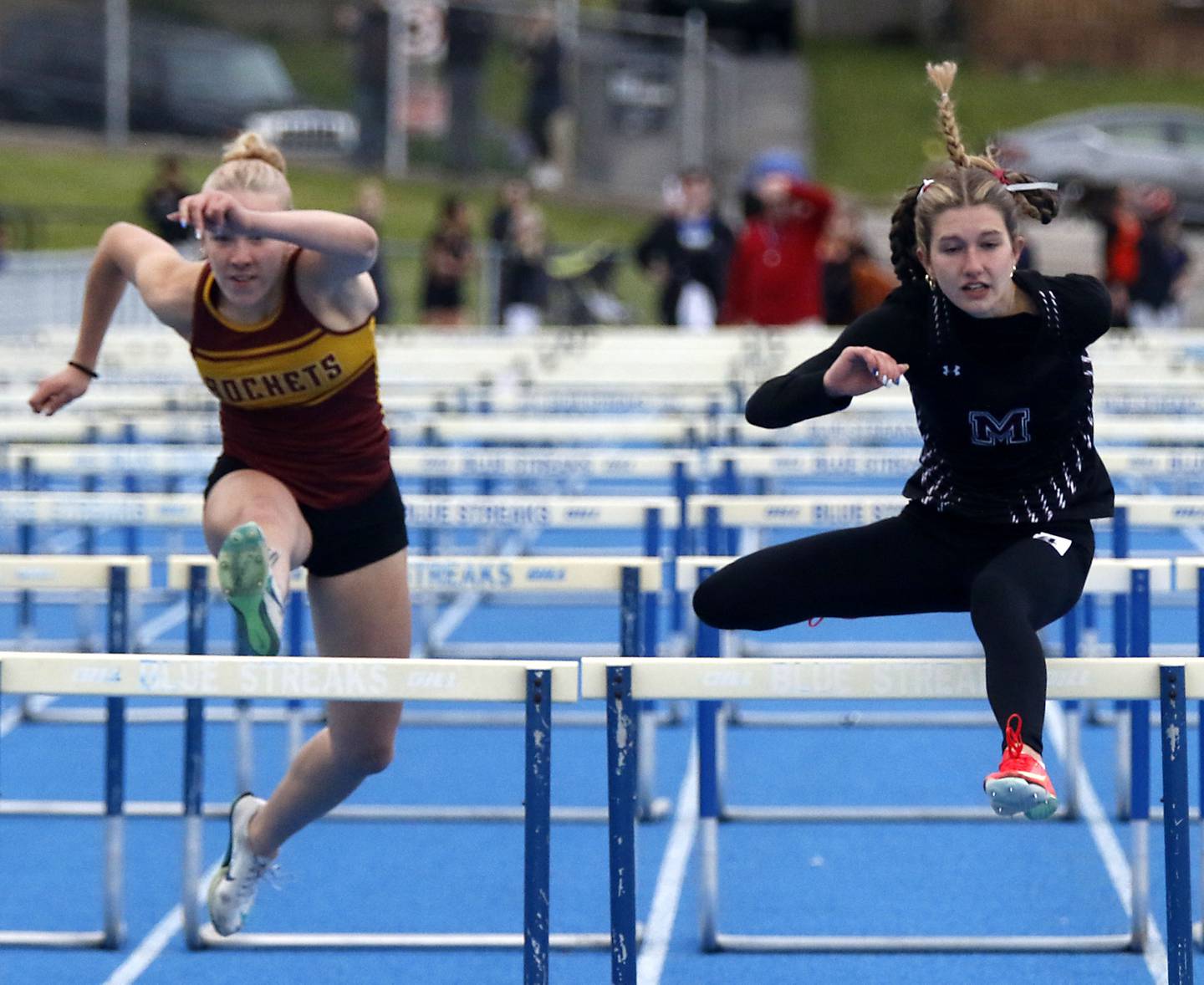 Richmond-Burton’s Emily Wisniewski and Marengo’a Olivia Walter compete in the 100 meter hurdles during the Kishwaukee River Conference Girls Track and Field Meet on Tuesday, May 5, 2025, at Woodstock High School.