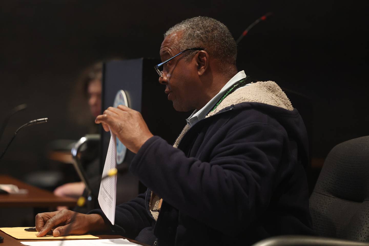 City Council candidate Michael Carruthers holds up list of his nominating petitions at a hearing on the validity of his nominating petitions at the Joliet City Electoral Board meeting on January 4th.