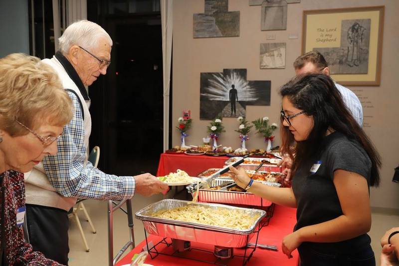 Jim Goebbert, center, and his wife, Esther, at left, and at a dinner for military veterans at Immanuel Lutheran Church in 2019.