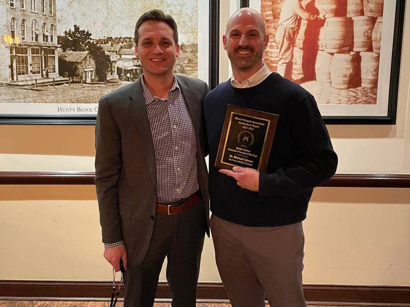McHenry School District 15 Superintendent Josh Reitz (left) congratulates McHenry Middle School Principal Mike Glover (right) on receiving Middle School Principal of the Year for the Illinois Principals Association Kishwaukee Region.