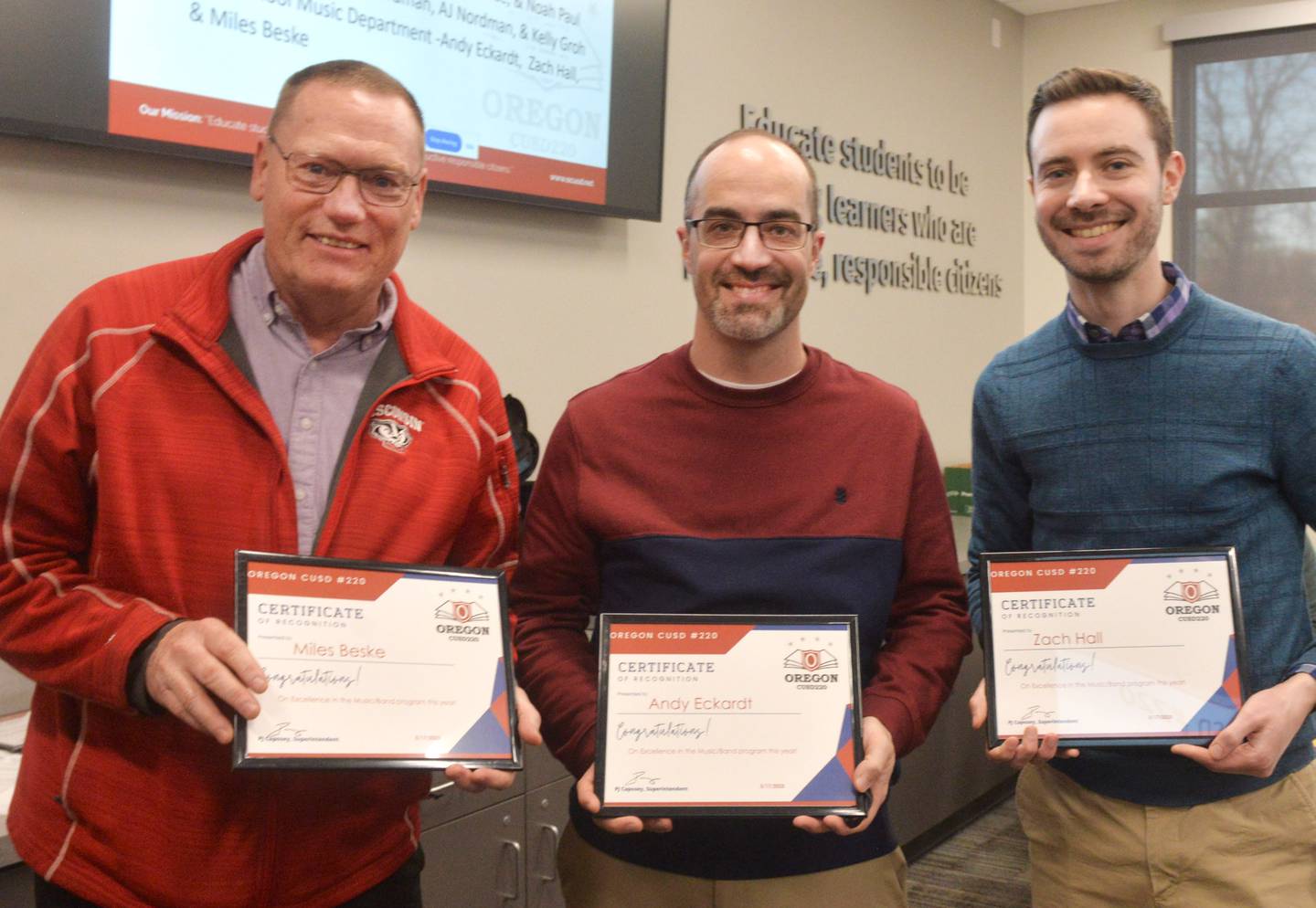 Music educators Miles Beske, Andy Eckardt, and Zach Hall pose with the certificates they received from the Oregon School Board on Monday, March 17, 2025 in recognition of student and program successes this year.