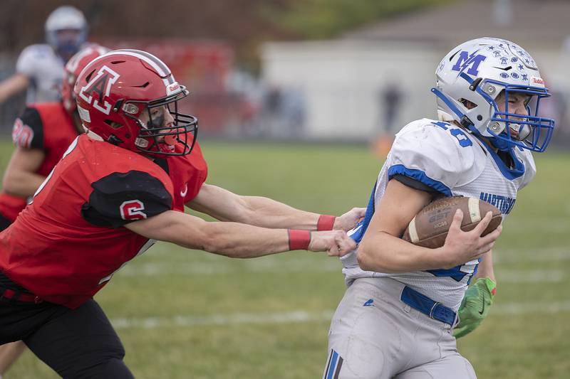 Martinsville’s Gabe Griffin runs away from Amboy’s Rylan McNinch Saturday, Nov. 9, 2024, in round two of the 8-man football playoffs.