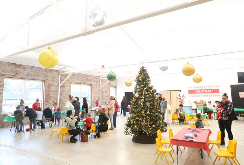 Kids make crafts at Santa's Workshop inside Ax Church during the Miracle on First Street event on Saturday, Dec. 2, 2023 in La Salle.