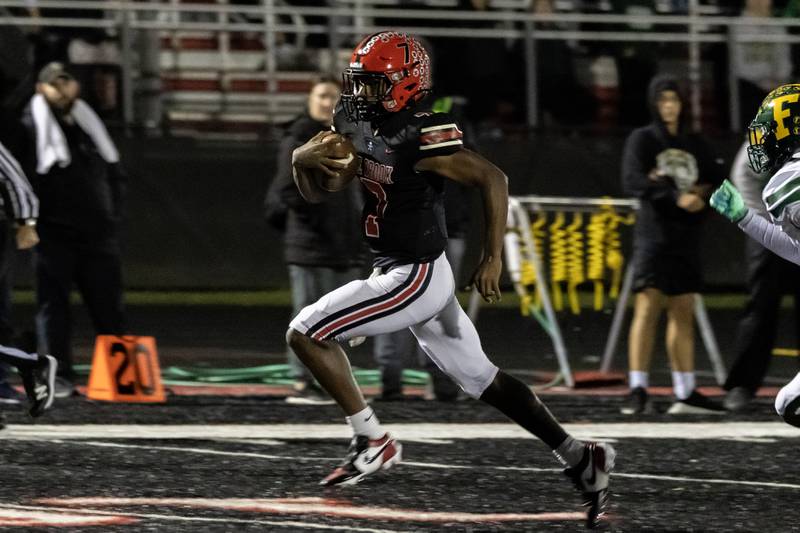 Bolingbrook's Tyson Ward breaks away from the pack before scoring a touchdown during an 8A varsity football playoff game against Fremd at Bolingbrook on Nov. 15, 2025.