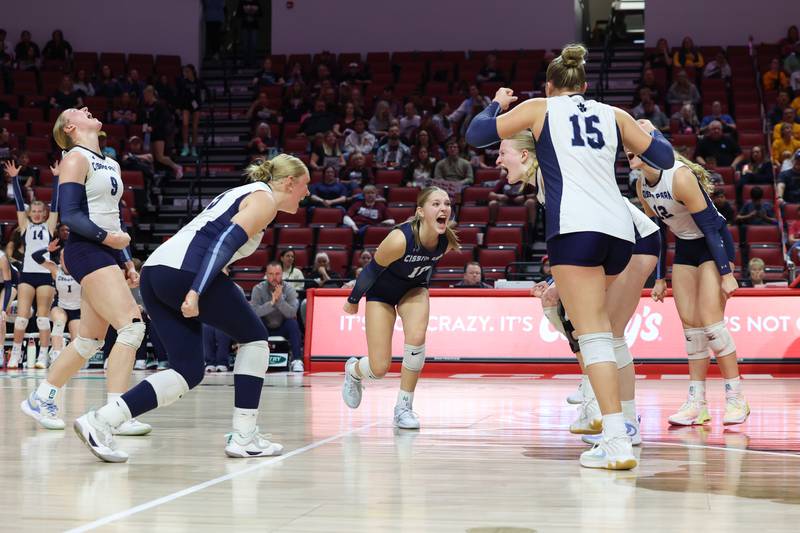 Cissna Park's Kendyl Neukomm, center, turns to celebrate a point with teammates during the Timberwolves' victory in two sets, 25-11, 25-14, over Stockton in the IHSA Class 1A State championship on Saturday, Nov. 15, 2025.
