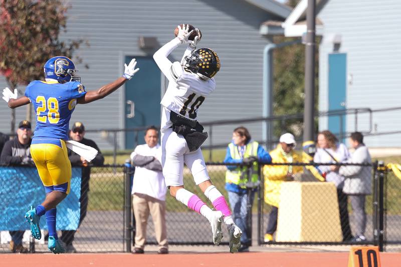 Joliet West’s Parker Schwarting pulls a pass on a touchdown catch and run against Joliet Central on Saturday.