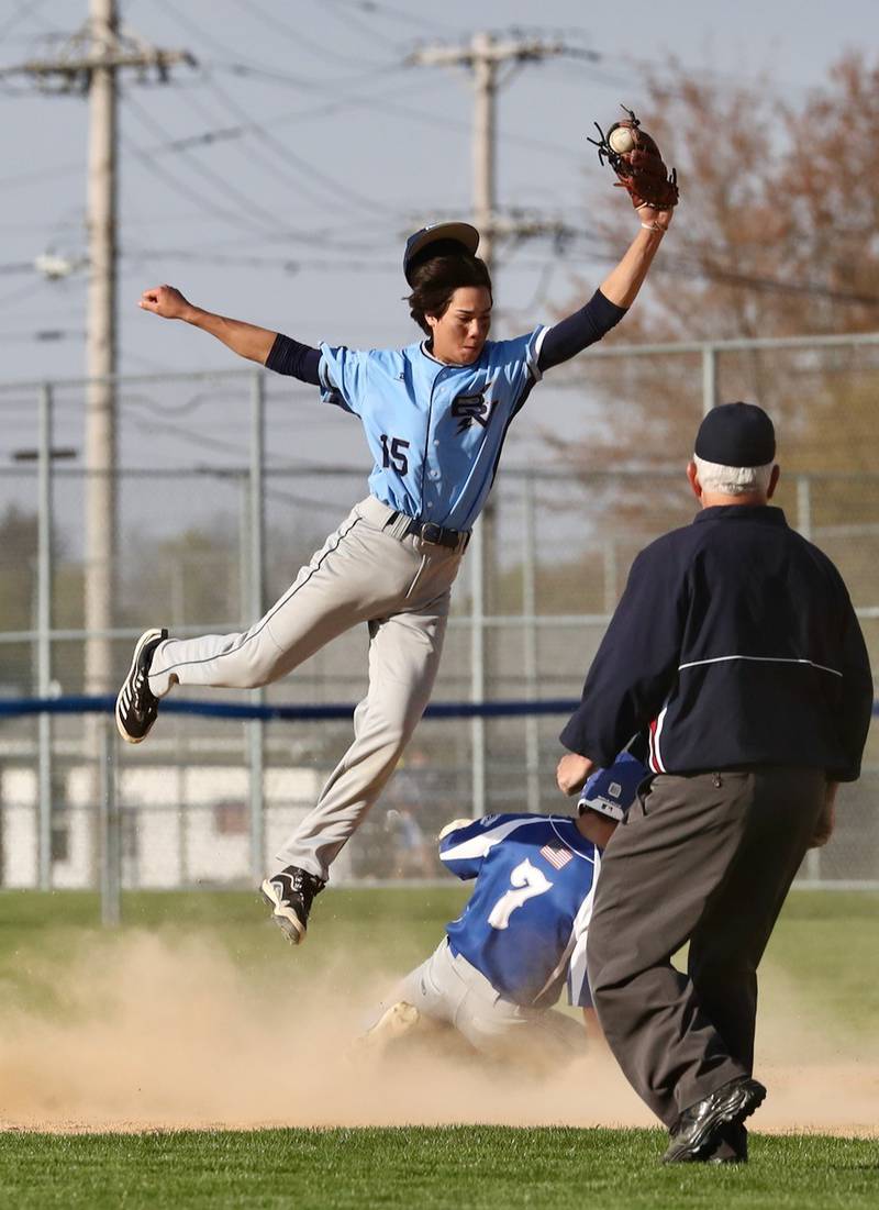 Bureau Valley short stop Corban Chhimm leaps to take a throw as Augie Christiansen steals second base Thursday.