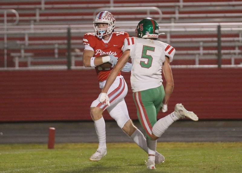 Ottawa's Owen Sanders eyes the end zone after making a catch over L-P's Reagan Doerr on Friday, Sept. 12, 2025 at King Field.