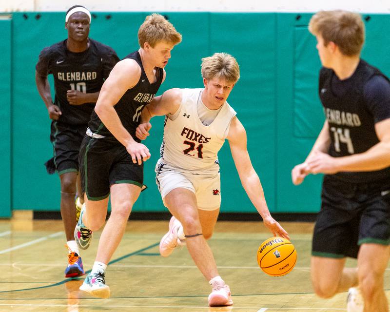 Yorkville's Frankie Pavlik dribbles up court against Glenbard West's Chase Cavan on Friday Dec. 26,2025 at the 51st. Annual Jack Tosh Holiday Tournament in Elmhurst.