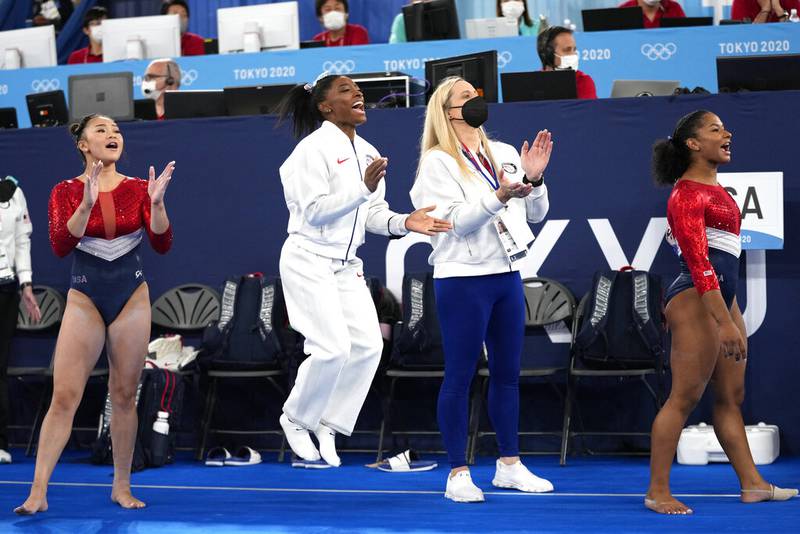 In this July 27, 2021 file photos, gymnasts from the United States, Simone Biles, center, Jordan Chiles , right, and Sunisa Lee cheer Grace McCallum as she performs on the floor during the artistic gymnastics women's final at the 2020 Summer Olympics, in Tokyo. Biles and Naomi Osaka are prominent young Black women under the pressure of a global Olympic spotlight that few human beings ever face. But being a young Black woman -- which, in American life, comes with its own built-in pressure to perform -- entails much more than meets the eye.