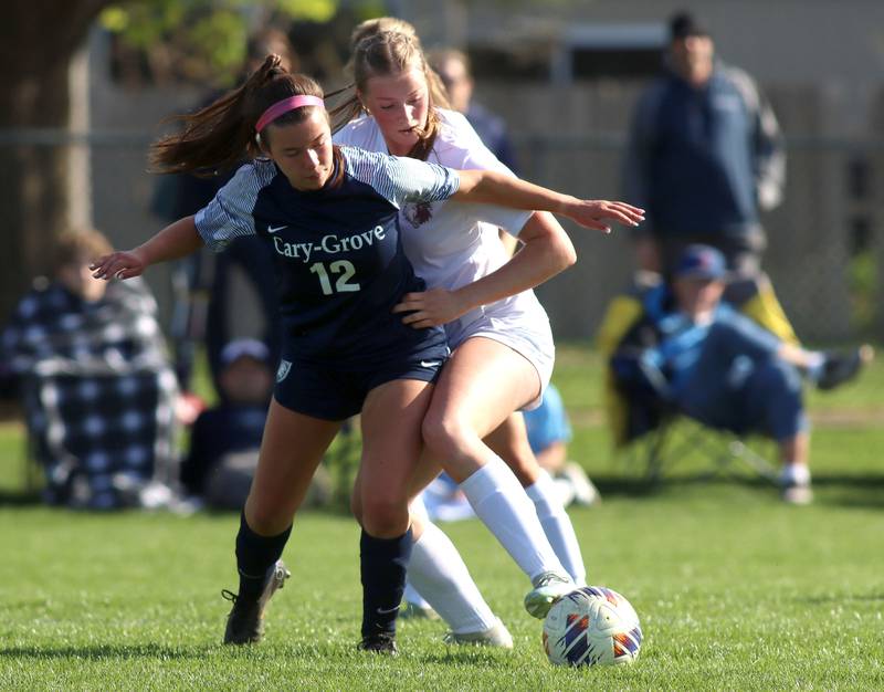 Cary-Grove’s Taylor Hamann, front, battles Prairie Ridge’s Anna Mertel in varsity girls soccer at Cary-Grove High School in Cary on Tuesday, April 29, 2025.