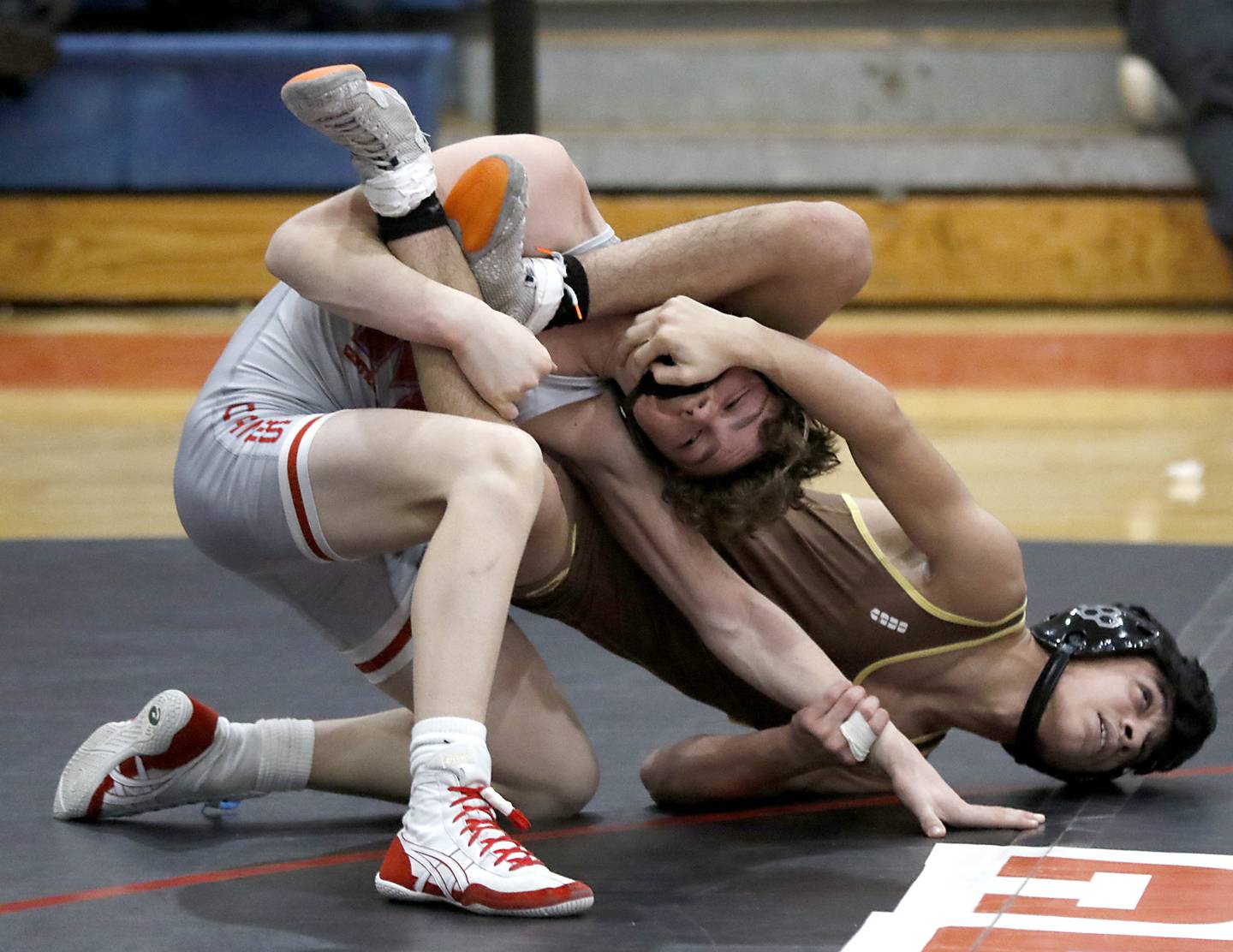 Marian Central's Camden Spiniolas tries to get away from Mt. Carmel's Sebastian Gracia in their 106-pound match during a triangle wrestling meet on Saturday Jan. 11, 2025, between Marian Central, Joliet Catholic, and Mt. Carmel at Marian Central High School in Woodstock.