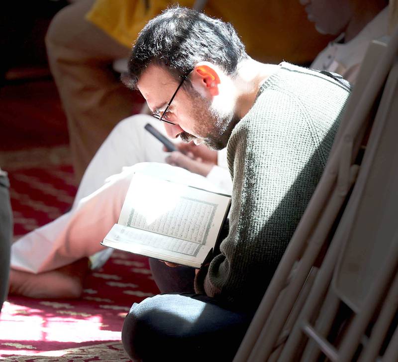 A man reads the Koran Friday, April 7, 2023, in the prayer hall, or musallā, at the Islamic Center of DeKalb. Muslims are currently observing the holy month of Ramadan.