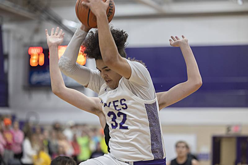 Dixon’s Darius Harrington hauls in a rebound against Sycamore Tuesday, Jan. 23, 2024 at Dixon High School.