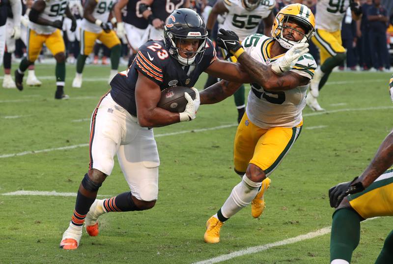 Chicago Bears running back Roschon Johnson fends off Green Bay Packers cornerback Keisean Nixon during their game Sunday, Sept. 10, 2023, at Soldier Field in Chicago.