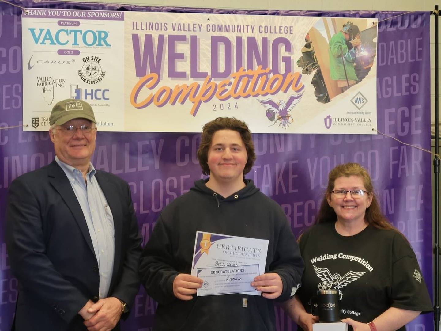 Brady Wawerski, Ottawa, earned first place and prizes in the college SMA welding division at the IVCC-AWS annual welding competition. He is pictured with Theresa Molln (right) and Ron Ashelford