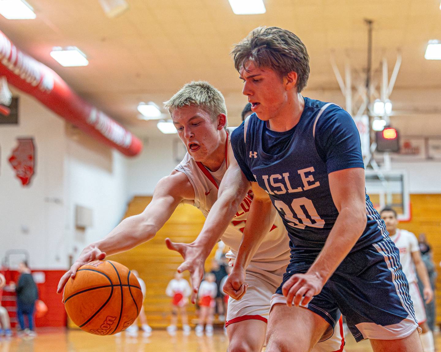 Streator's Joe Hoekstra (25) and Lisle's Frankie Zifcak (30) reach for a loose ball Wednesday, Feb. 18, 2026, at Streator's Pops Dale Gymnasium.
