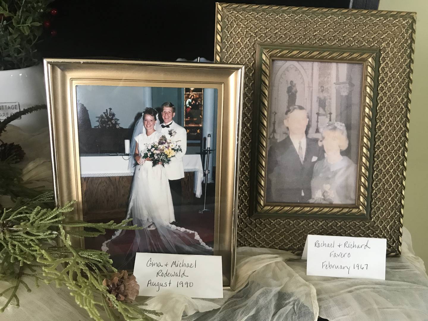 Wedding photos of Gina Rodewald, left, and Rachael and Richard Favero sit on the stand of Gina’s home. Gina’s daughter, Abigail, was the fifth generation of women in their family to get married at St. Joseph Catholic Church in Lockport.