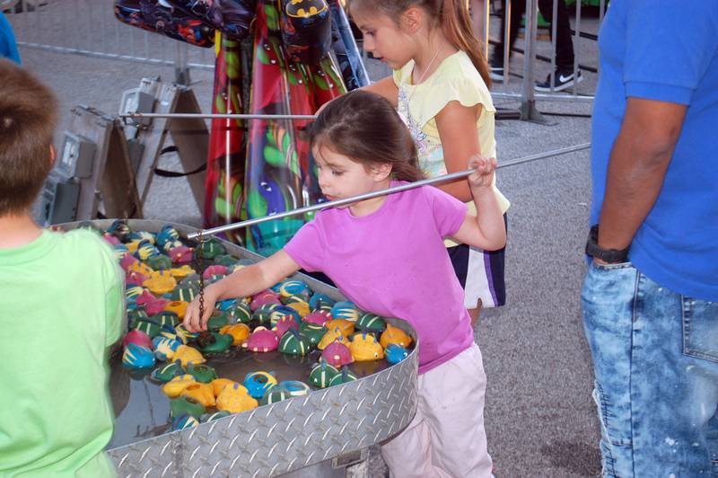 Children participate in a fishing carnival game at Streator Park Fest on Friday, May 26, 2023.