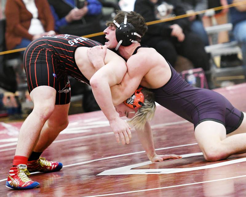 Dixon's Steven Kitzman (right) leans into Fulton's Zane Pannell at the start of their 170-pound match at the 1A Oregon Wrestling Sectional on Friday night.