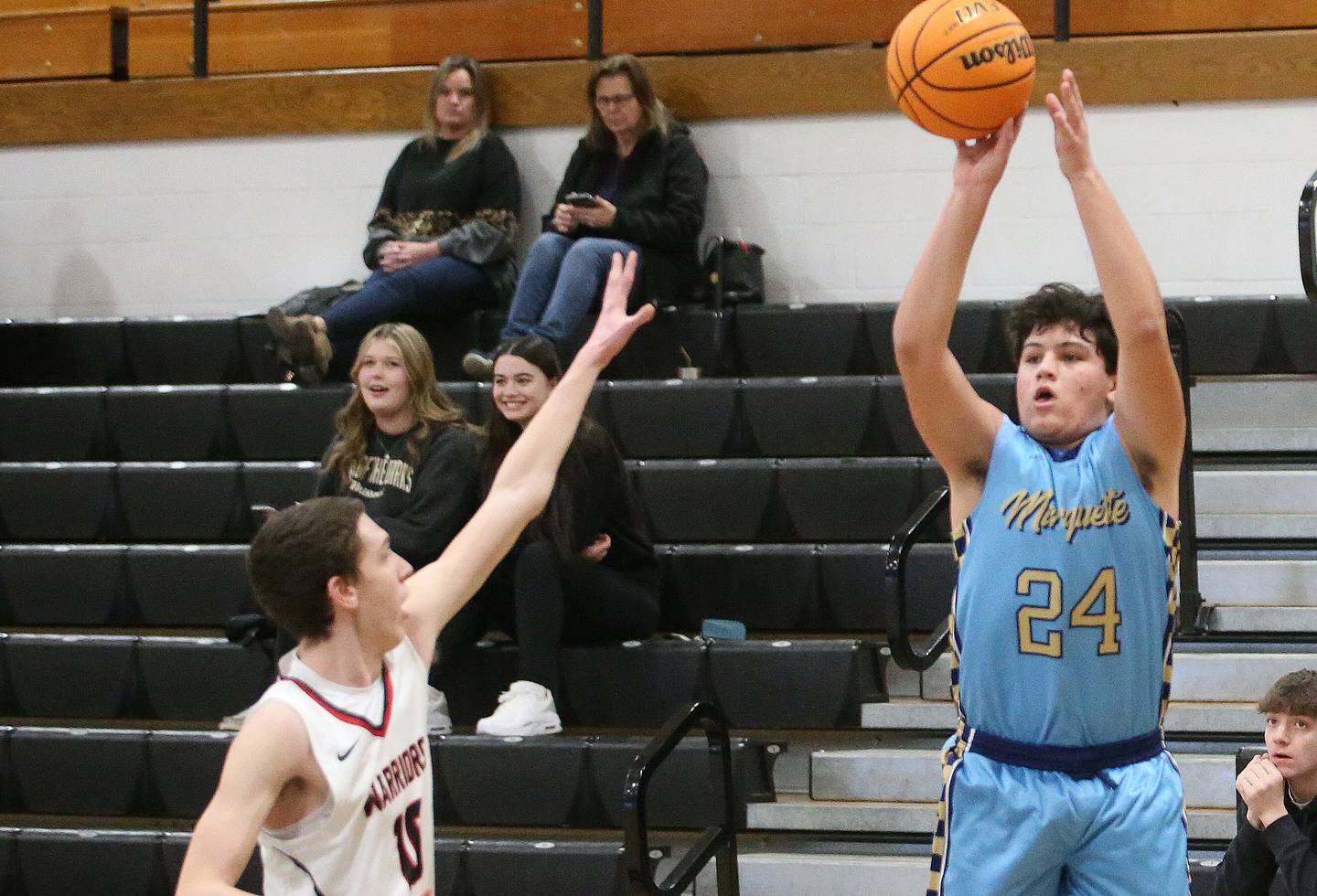 Marquette's Matt Graham shoots a jump shot over Woodland's Jaron Follmer during the Tri-County Conference Tournament on Tuesday, Jan. 28. 2025 at Putnam County High School.