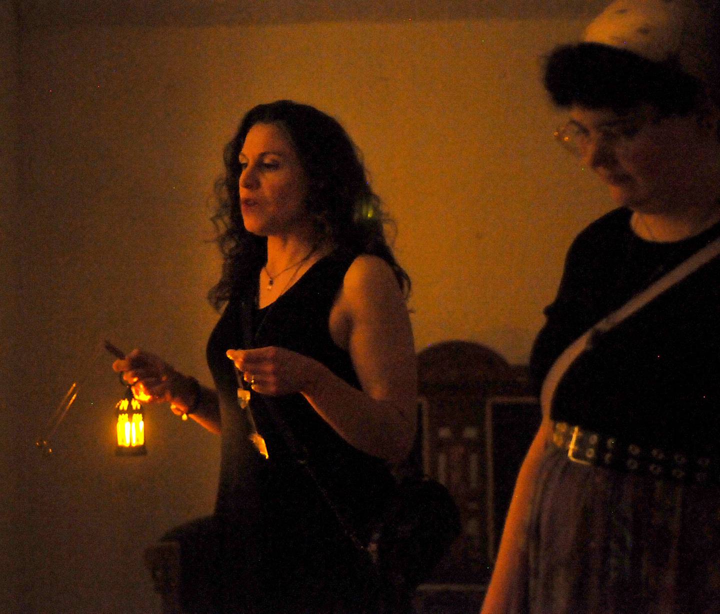 Loren Purcell, left, leads a paranormal tour Saturday, June 11, 2022, inside the Dole Mansion, 401 Country Club Road in Crystal Lake. Purcell started offering the tours this spring in the mansion. She takes guests through the original building's three floors and offers historical anecdotes through the lens of spirit visitations while guests use pendulum crystals and dowsing rods as part of the tours for experiencing the visitations.