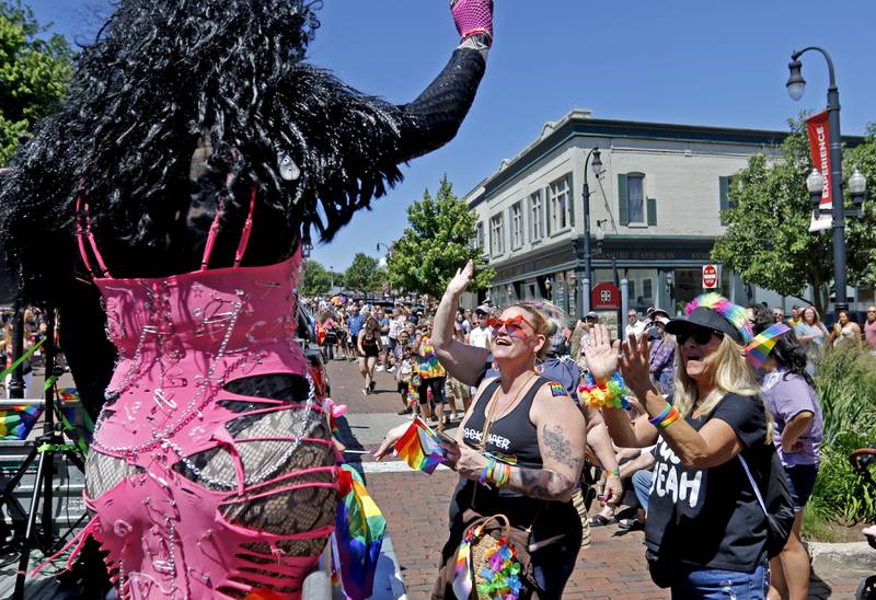 Fans react to the a drag queen during the Woodstock PrideFest Parade on Sunday, June 9, 2024, around the historic Woodstock Square.