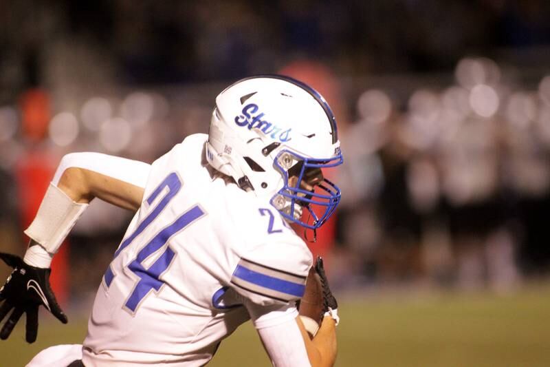 St. Charles North’s Jaden Harmon carries the ball after an interception during a game at Wheaton North on Friday, Sept. 8, 2023.