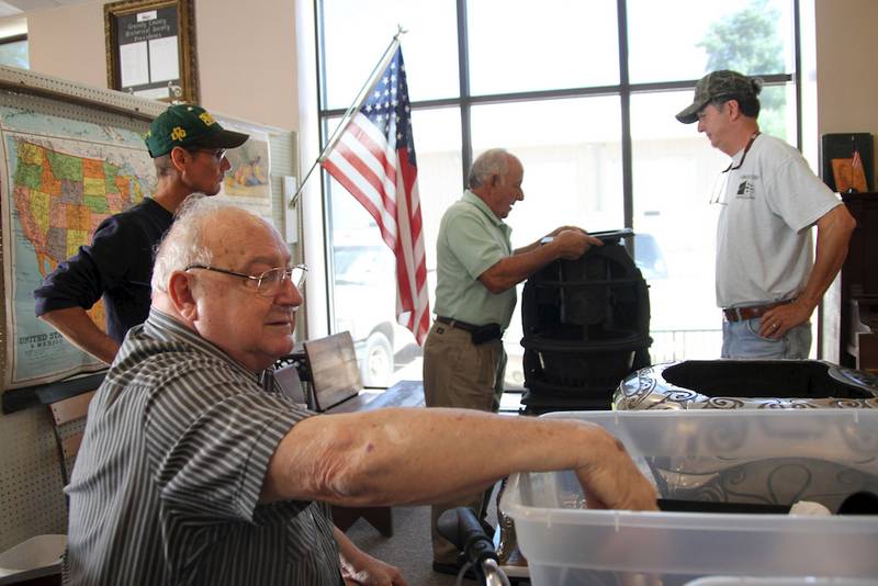 Jerry Sidenstick pulls parts of the coal burning stove he donated to the historical museum out of a box to rebuild the antique Royal Acorn #47 stove.