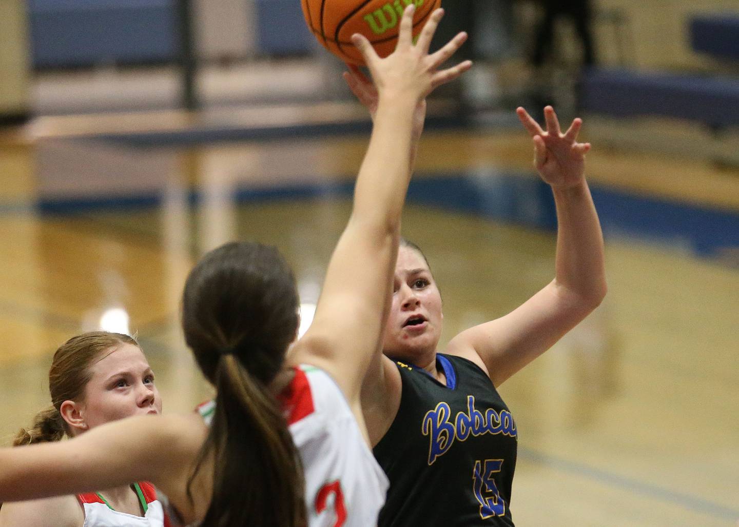 Somonauk/Leland's Kiley Mason (15) sneaks into the lane as La Salle-Peru's Elizabeth Sines and teammate Brie Ruppert defend during the Tim Humes Breakout Tournament on Friday, Nov. 22, 2024, at Somonauk High School.