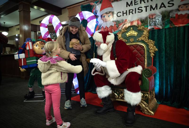 A family talks with Santa Claus at the Kankakee Train Depot on Thursday, December 4, 2025.