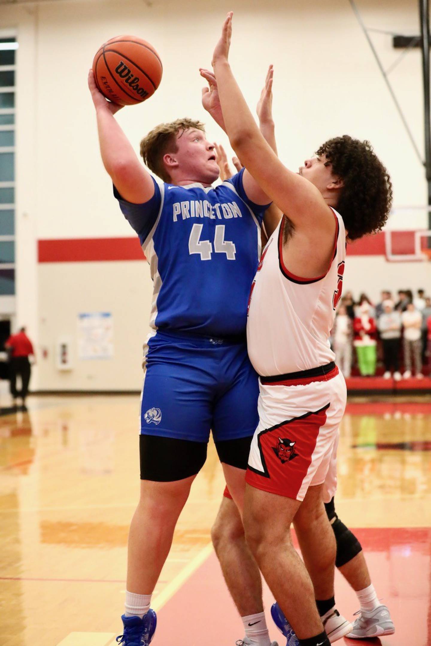 Princeton junior Luke Smith tries to shoot over Hall's Anthony Reeser in the second half of Friday's game in Spring Valley. The Tigers won 63-47.