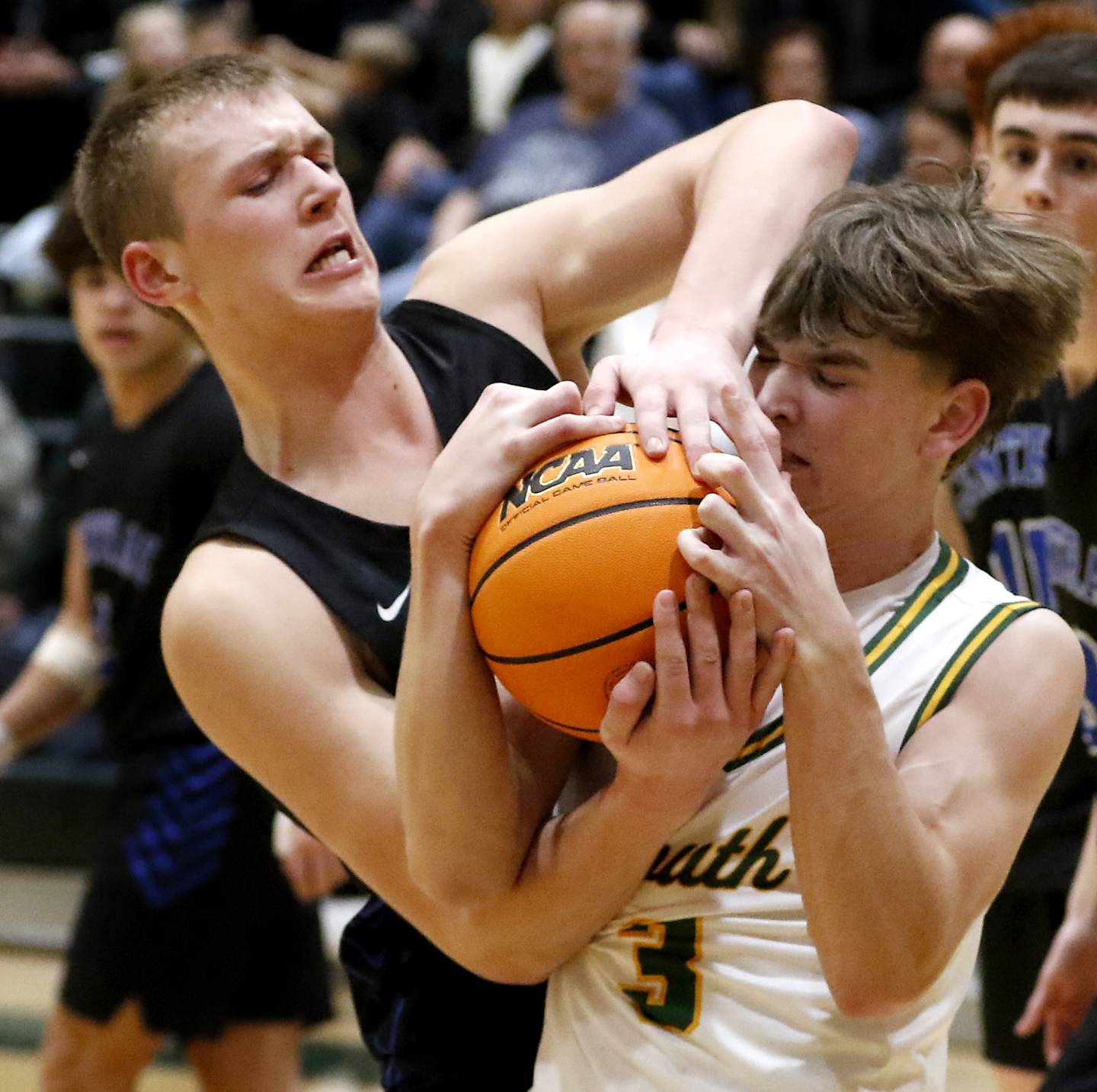 Burlington Central's Jacob Johnson tries to get the ball away from Crystal Lake South's Nick Stowasser during a Fox Valley Conference basketball game on Tuesday, Jan. 28, 2025, at Crystal Lake South High School.