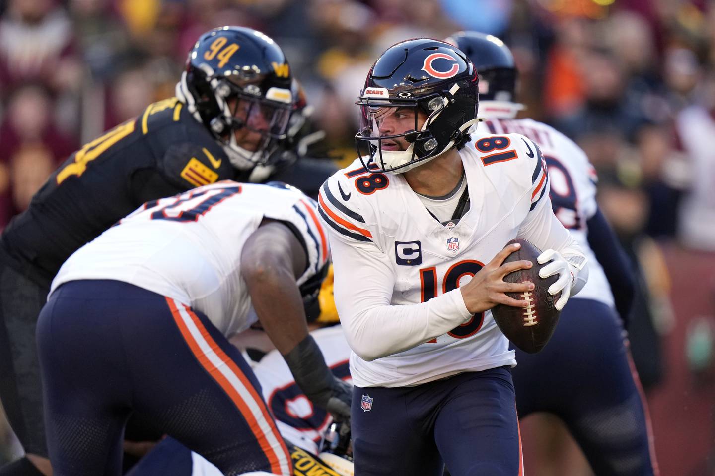 Chicago Bears quarterback Caleb Williams (18) looks for a receiver in the first half of an NFL football game against the Washington Commanders Sunday, Oct. 27, 2024, in Landover, Md. (AP Photo/Stephanie Scarbrough)