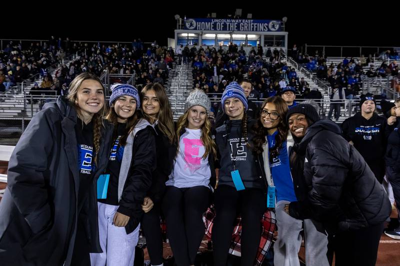 Lincoln-Way East’s managers take a photo prior to a varsity football round one playoff game against Stevenson at Lincoln-Way East on Oct. 31, 2025.