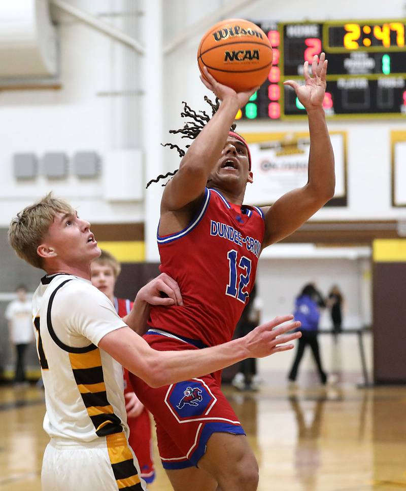 Dundee-Crown's Anthony Spain shoots the ball over Jacobs' Carson Goehring during a Fox Valley Conference boys basketball game on Tuesday, February. 3, 2026, at Jacobs High School in Algonquin.