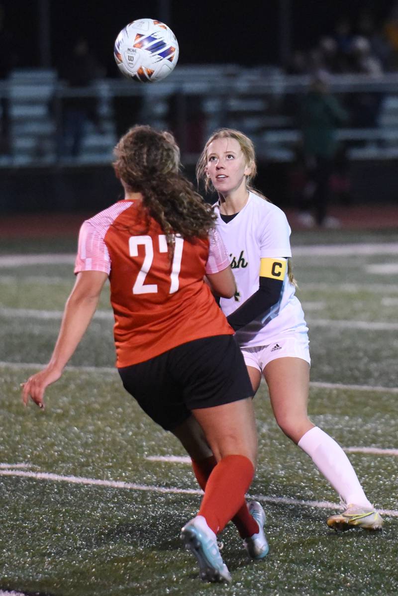Bishop McNamara's Lydia Nugent, right, prepares to head the ball as Bradley-Bourbonnais' Aaliyah Lanum approaches during a game at Bradley-Bourbonnais Tuesday, April 1, 2025.
