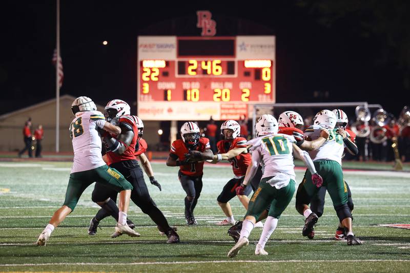 Bradley-Bourbonnais quarterback Ellis Johnson hands the ball off to Kyren Edmon, left center, during the Boilermakers' 35-6 victory over Waubonsie Valley Friday, Sept. 12, 2025.