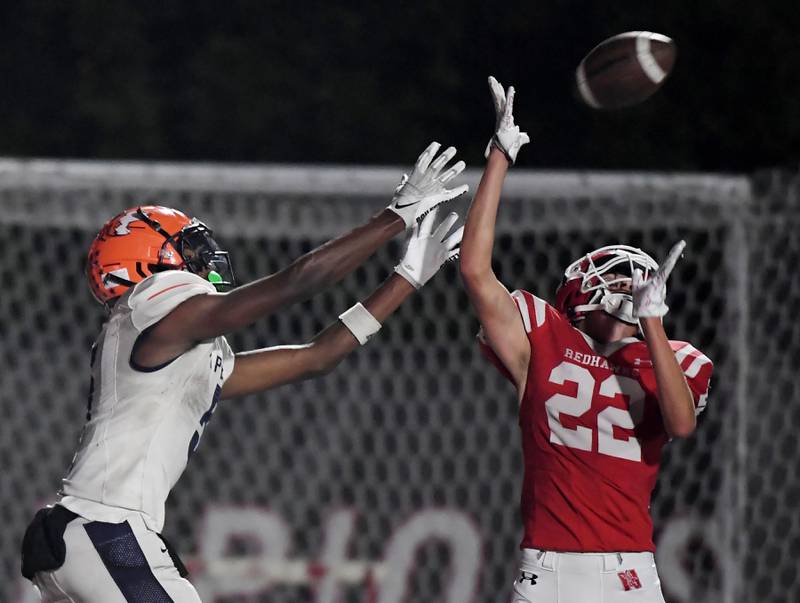 Naperville Central’s Nathan Monken breaks up a pass for Naperville North’s Luke Williams in a high school football game at North Central College in Naperville on Friday, September 29, 2023.