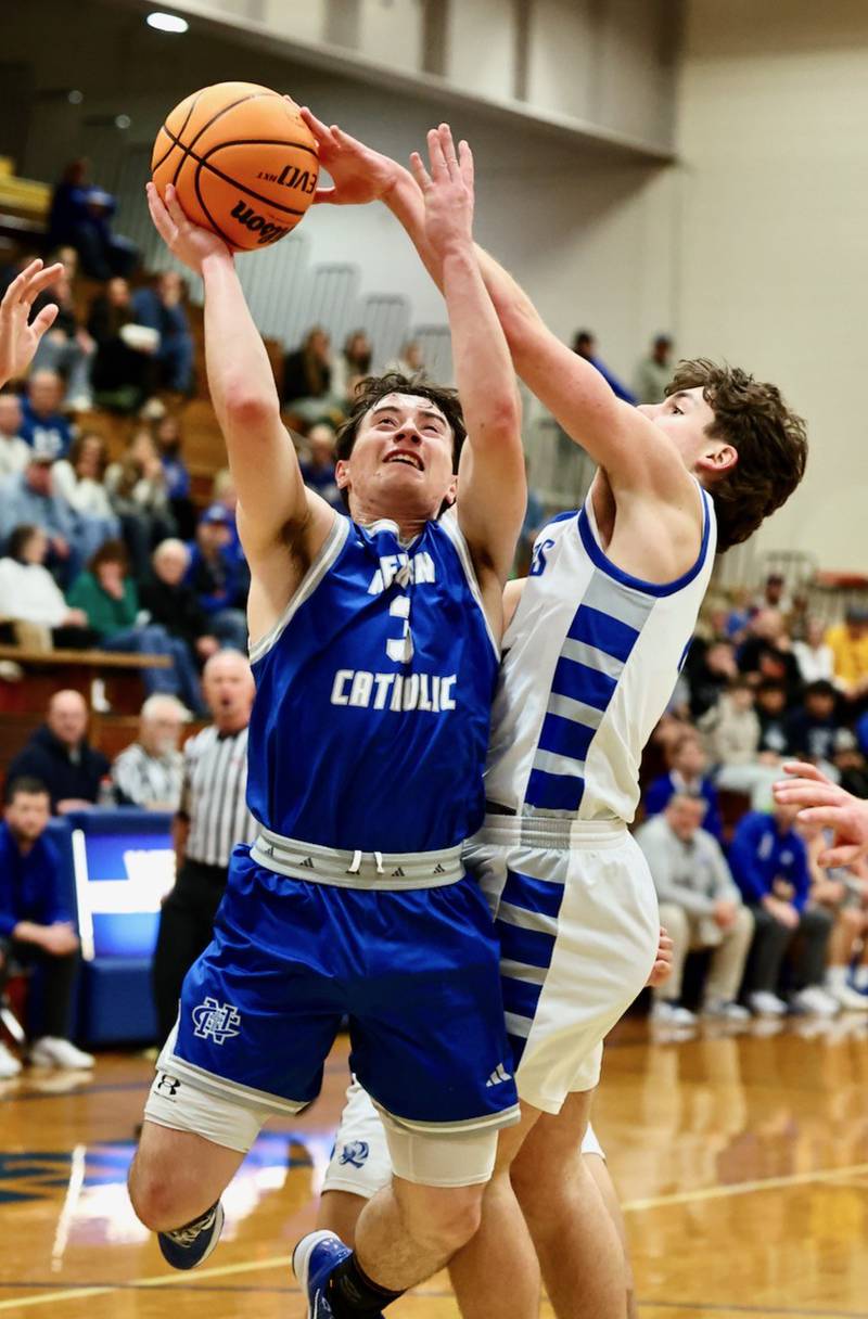 Newman's Garrett Matznick shoots over Princeton's Deacon Gutshall Saturday night at Prouty Gym.