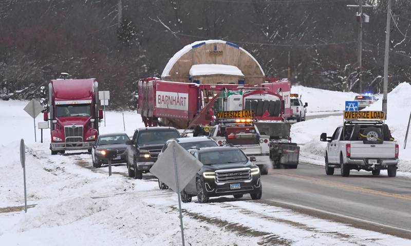 The tractor and trailer pulling and pushing one of the large turbines for Constellation's Byron generating station heads east on state Route 64, east of Oregon, on Monday, Dec. 8, 2025.