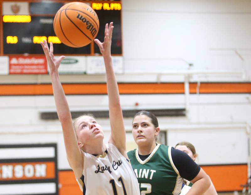 Marquette's Keely Nelson grabs a rebound over St. Bede's Ava Balestri during the Tri-County Conference championship game on Thursday, Jan. 23, 2025 at Roanoke-Benson High School.