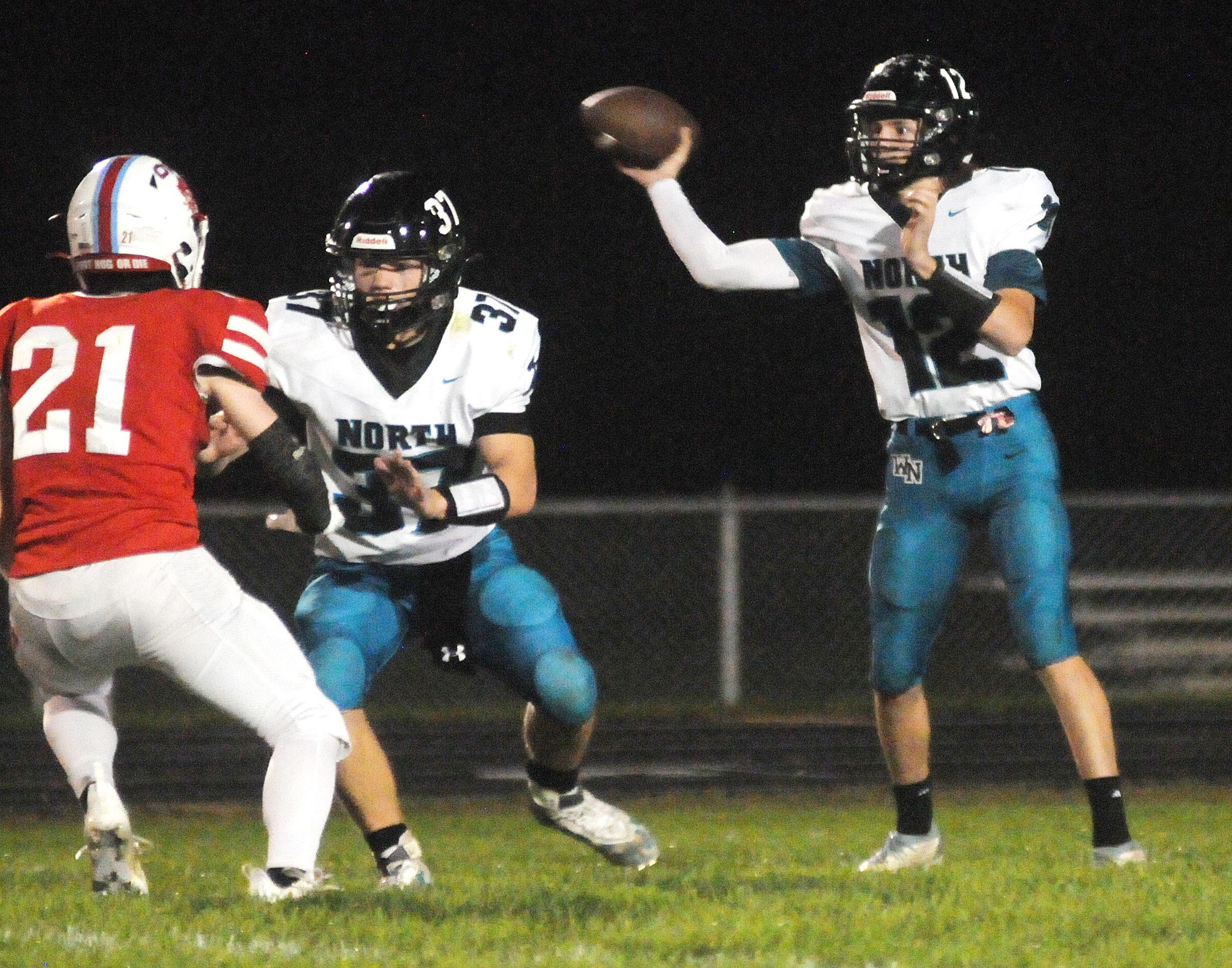 Woodstock North's Kaden Combs (37) protects quarterback Landon Creighton from Ottawa's Garrett Cupples at King Field on Friday, Sept. 29, 2023.