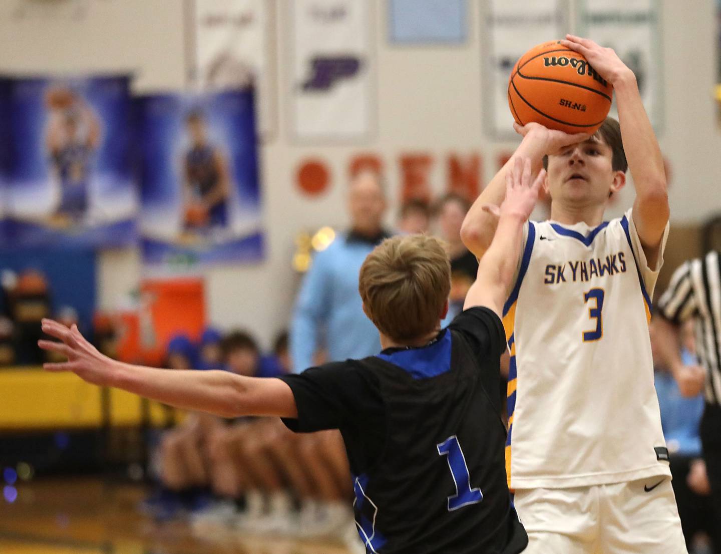 Johnsburg's Trey Toussaint shoots the bal over Woodstock's Rian Hahn Clifton during a Kishwaukee River Conference boys basketball game on Friday, February. 13, 2026, at Johnsburg High School.