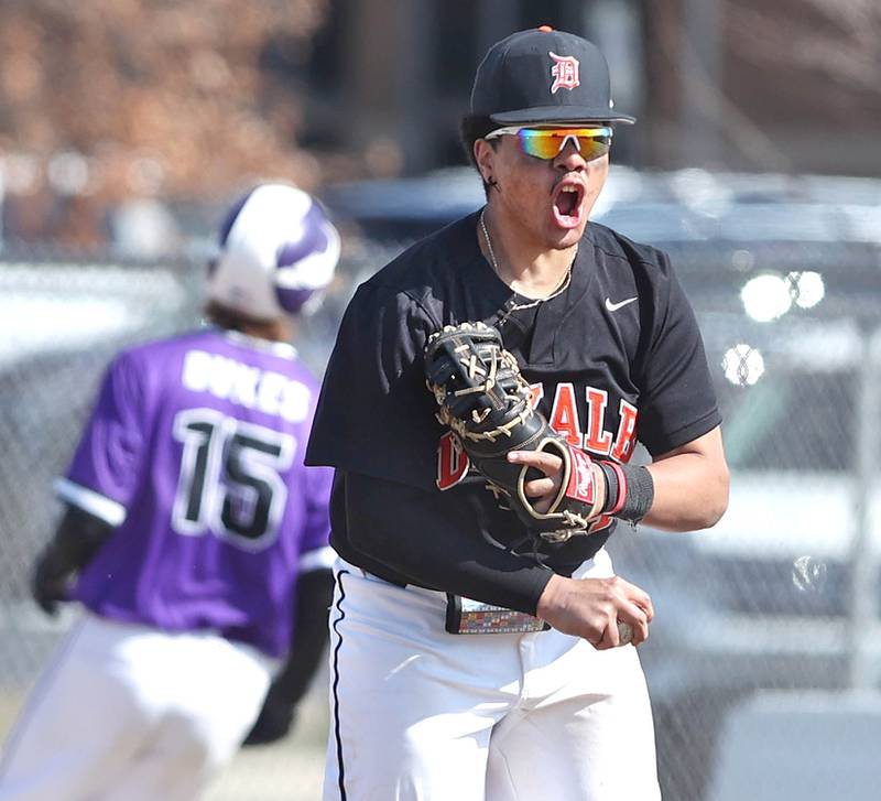 DeKalb’s Maddux Clarence reacts after picking a throw out of the dirt saving a run during their game against Dixon Tuesday, March 28, 2023, at DeKalb High School.