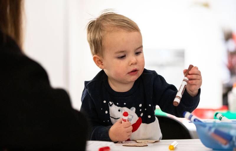 Caleb Ray, 2, selects a marker to color his ornament with during a Merry & Bright Victorian Christmas at the Downers Grove Museum on Saturday, Dec. 14, 2024.