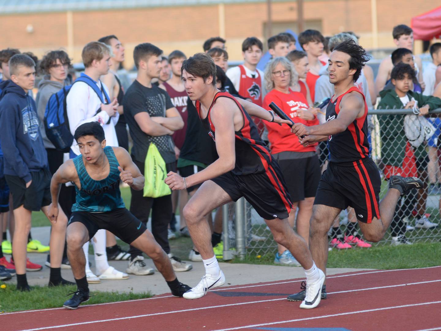 Forreston-Polo's DeAngelo Fernandez hands the baton to Noah Dewey during the 800 meter relay at the Hawk Classic in Oregon on Friday, April 28.