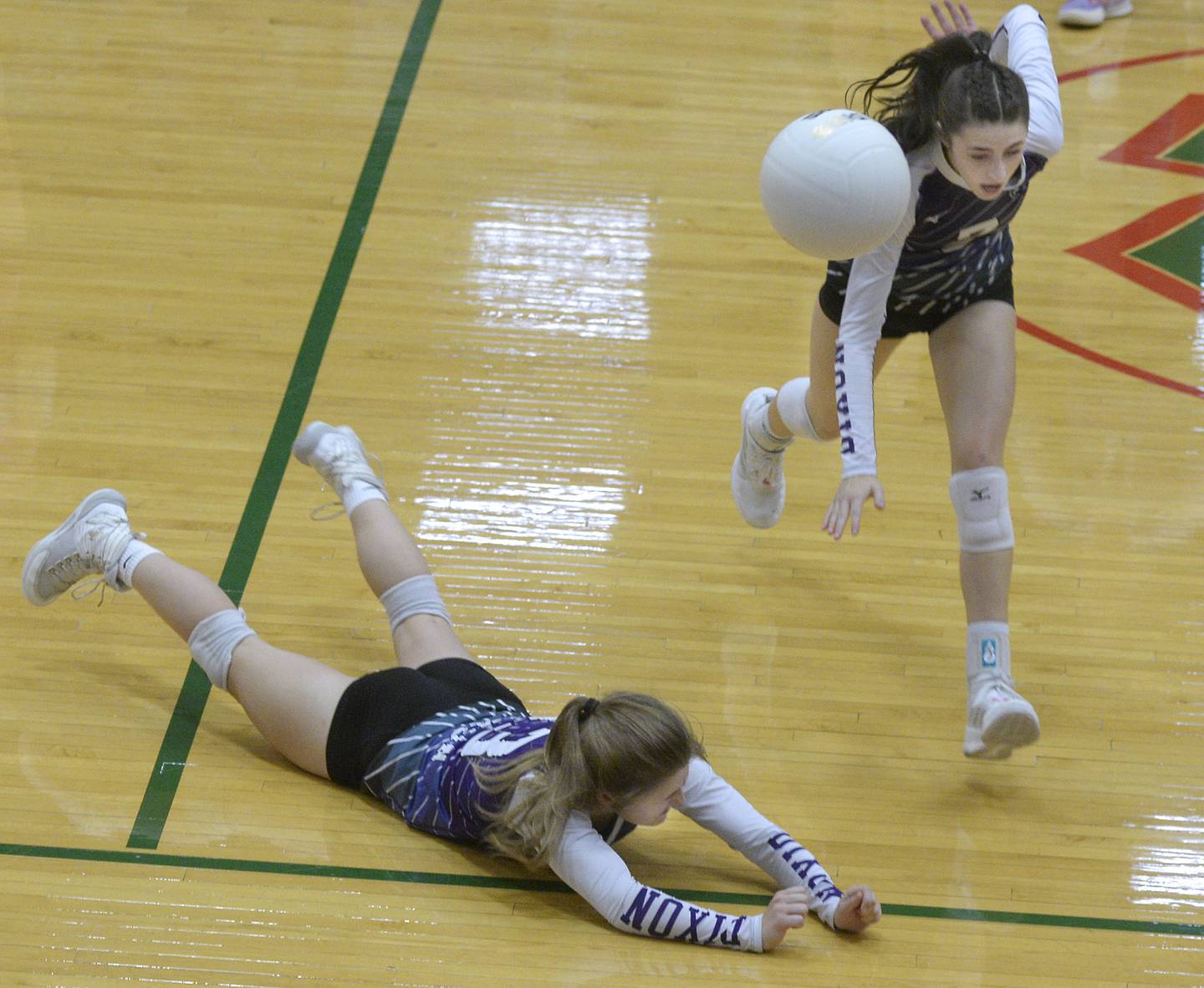 Dixon’s Hanna Linguist and Sydney Hargrave fall short of stopping a spike in the second match during the Class 3A Sectional semifinal game on Monday, Oct. 31, 2022 at La Salle-Peru Township High School.