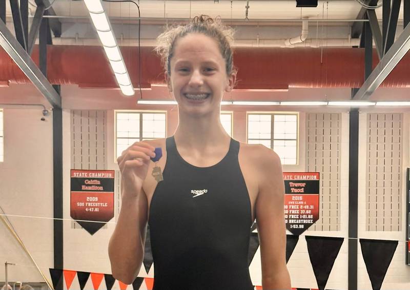 La Salle-Peru co--op's Sam Nauman, a freshman from Henry-Senachwine, poses with her medal after winning the 100-yard backstroke at the Normal Community Sectional to earn a trip to state.